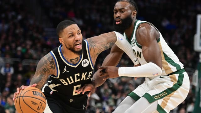 Milwaukee Bucks guard Damian Lillard (0) drives for the basket against Boston Celtics center Jaylen Brown (7) 